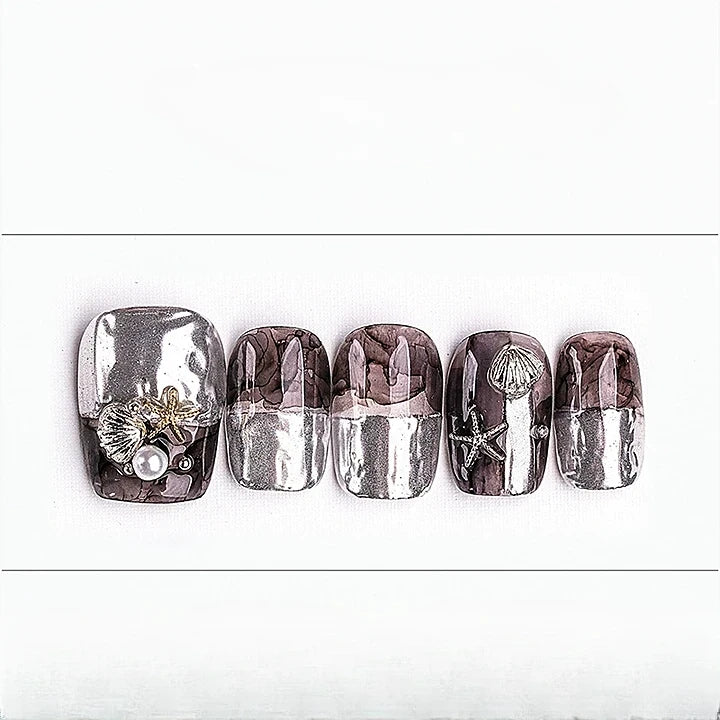 Set of five nail art designs with seashells, pearls, and starfish on a white background
