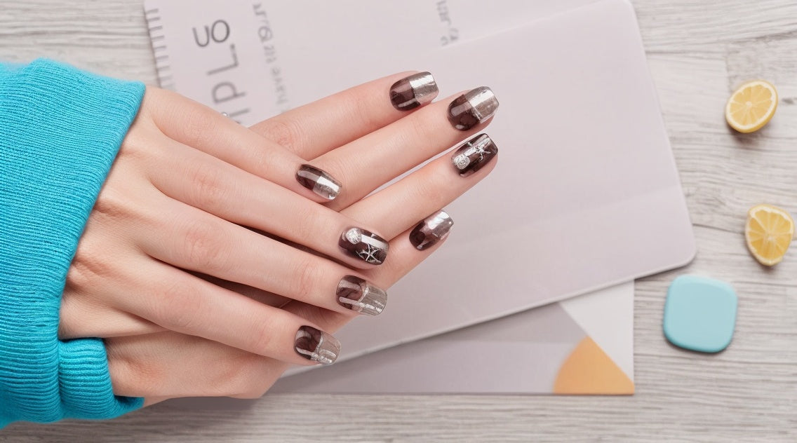 Hand with metallic nail polish on a light background