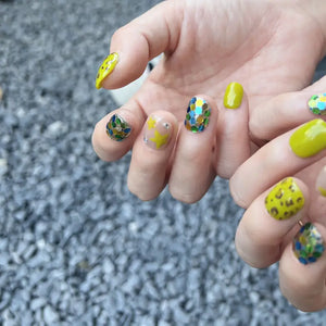Hand with colorful nail art on a blurred background