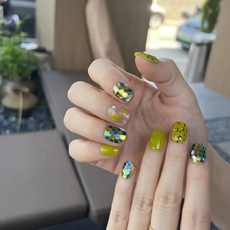 Hand with colorful nail art in a casual setting